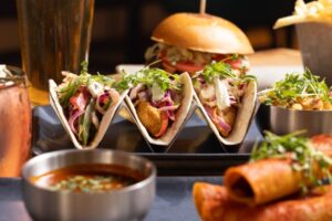 Baja chicken tacos with fresh salsa and beer served at Cafe Americano, perfect for late night food Miami Beach near the Boat Show