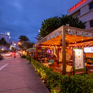 Illuminated outdoor terrace at Cafe Americano on Collins Ave, one of the top restaurants near Miami Boat Show for al fresco dining